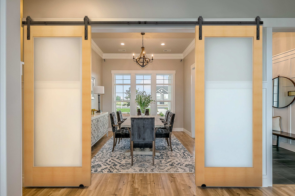 Modern Double Barn Door with light wood and frosted glass, opening to a formal dining room.