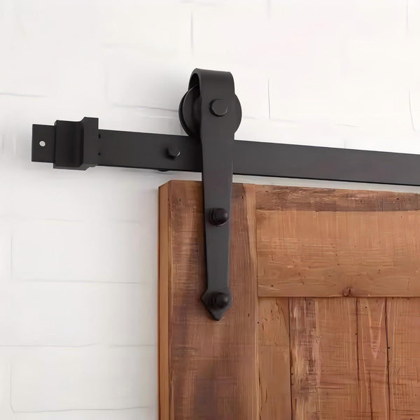 Black carbon steel barn door hardware kit with arrow design on wooden barn door